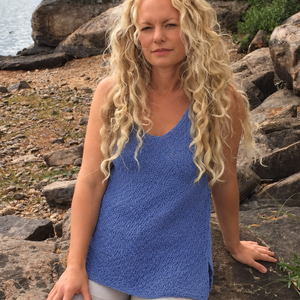 Woman wearing the Elvi loose singlet #101 in denim blue with shorts