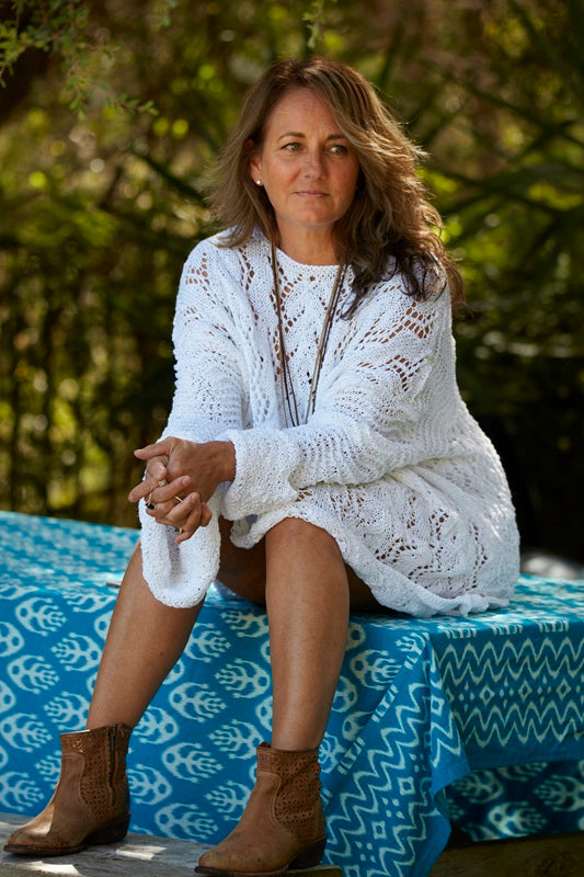 Woman wearing the white Lace Tunic #107, showing the wide lace sleeves