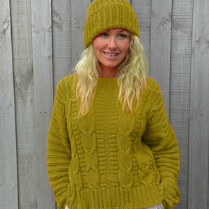 Woman wearing the Elisabeth Cable Jumper #113 and a matching beanie in Scandi Soft XL Chartreuse