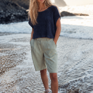 Tuva T-shirt #126 in navy, a boxy cotton knit worn with shorts on the beach