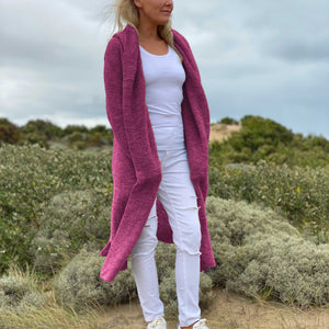 Elna hooded cardigan #133 in wild berry, worn open over white – a long knitted coat that reaches the knees