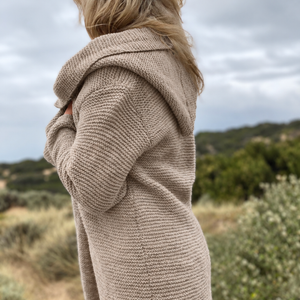 Elna hooded cardigan #133 in putty, seen from the side with the hood resting on the shoulders, knitted in chunky Scandi Soft XL