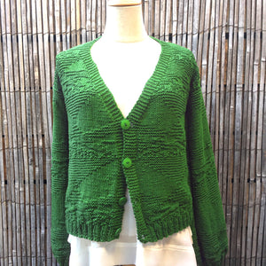 The Textured Cardigan #142 in emerald green with buttons, shown on a mannequin