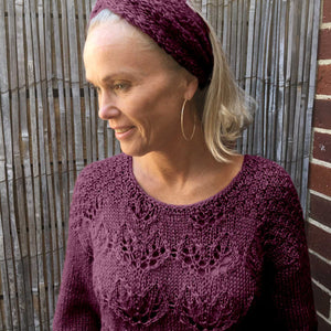 Woman wearing the Ingrid lace jumper #149 in Snö Mulberry with a matching headband