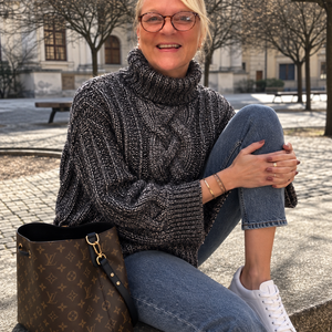 Hedda Cable Roll Neck #150 in silver, an oversized cable knit worn with jeans outdoors