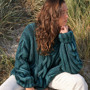 Hedda Cable Roll Neck #150 in turquoise, showing the central cable panel, in the dunes