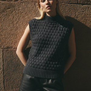 Woman wearing the Bubble Vest #169 in black with a leather skirt