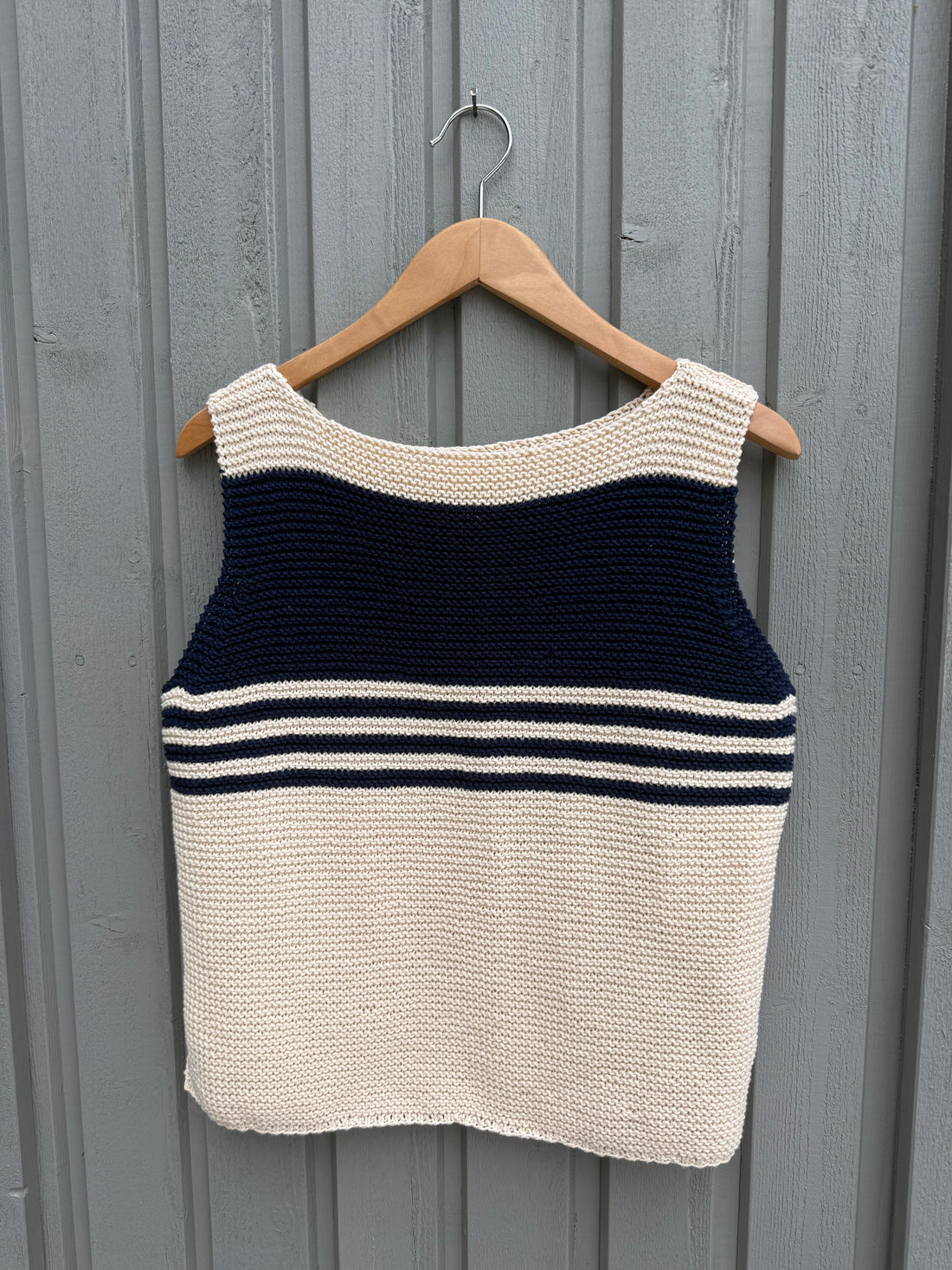 Frida Top #179 on a hanger, striped side out, with a navy band across the chest