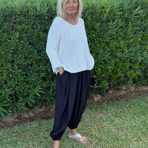 Vilja One Size Sweater #301 in white, knitted in chunky Scandi Cotton XL and worn with dark trousers