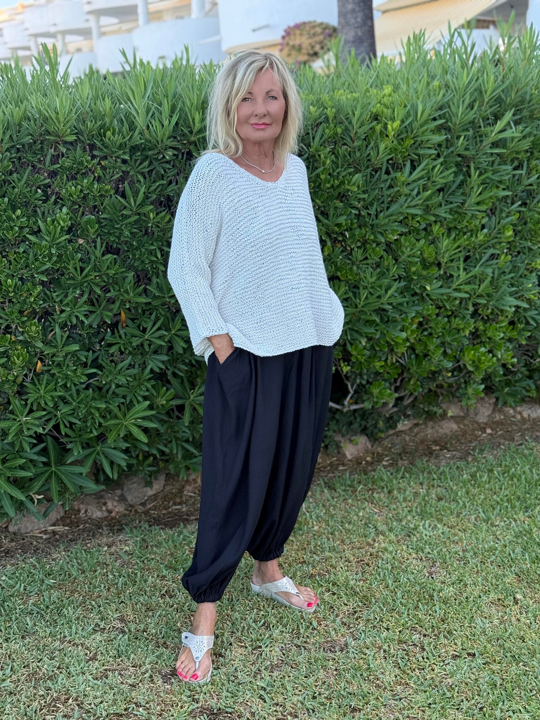Vilja One Size Sweater #301 in white, knitted in chunky Scandi Cotton XL and worn with dark trousers