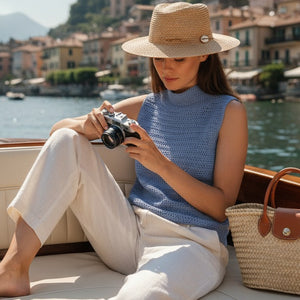 Woman in a straw hat wearing the Crochet Top #190 in sky blue