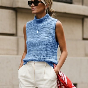 Woman wearing the Crochet Top #190 in sky blue with cream trousers