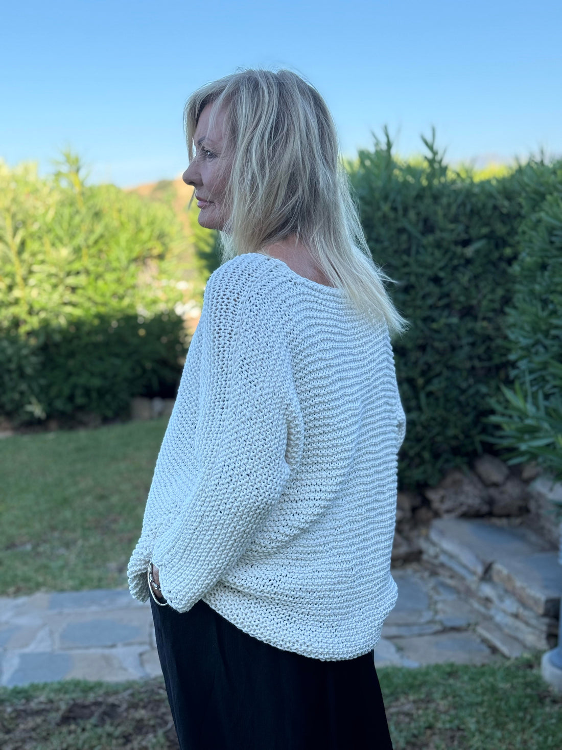 Side view of the Vilja sweater #301 in white, showing the grown-on sleeves and relaxed fit