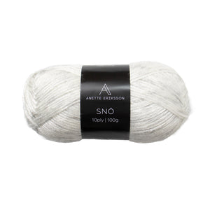 A ball of Anette Eriksson Snö yarn in Ice, an off-white shimmering wool blend