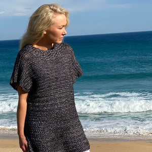 Woman on the beach wearing the Crochet Tunic #148 in silver Frost