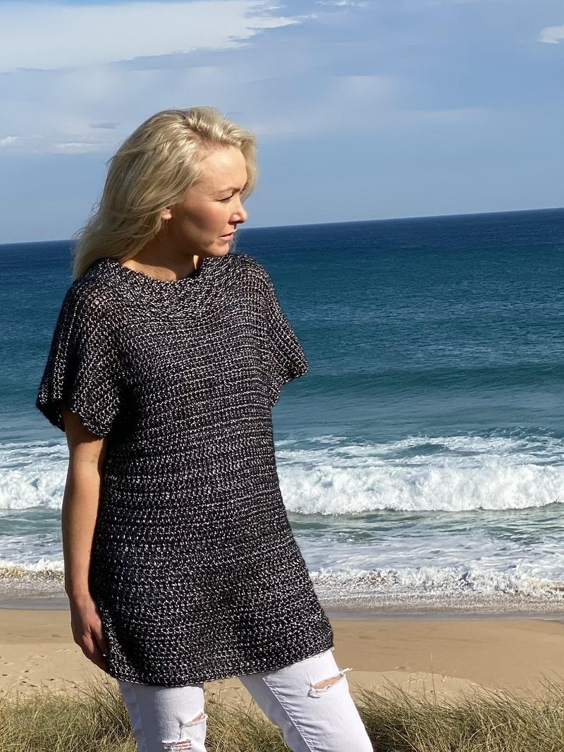 Woman on the beach wearing the Crochet Tunic #148 in silver Frost
