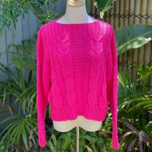 The Elisabeth cable jumper #113 in cerise, showing the ribbed hem and cuffs