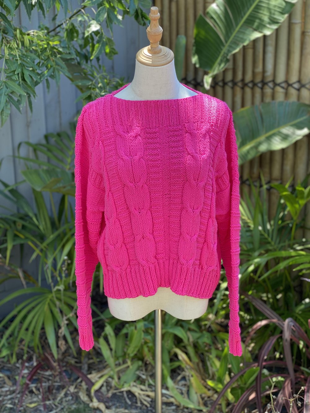 The Elisabeth cable jumper #113 in cerise, showing the ribbed hem and cuffs