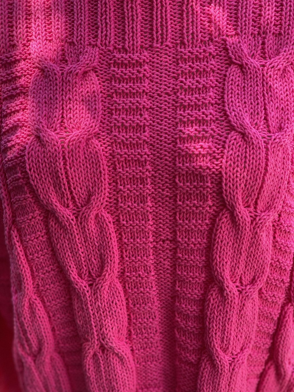 Close-up of the cable panel on the Elisabeth cable jumper #113 in cerise