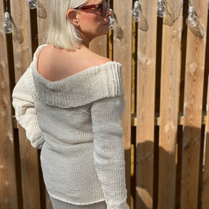 Woman wearing the Bardot off-shoulder jumper #125 in cream, worn off one shoulder