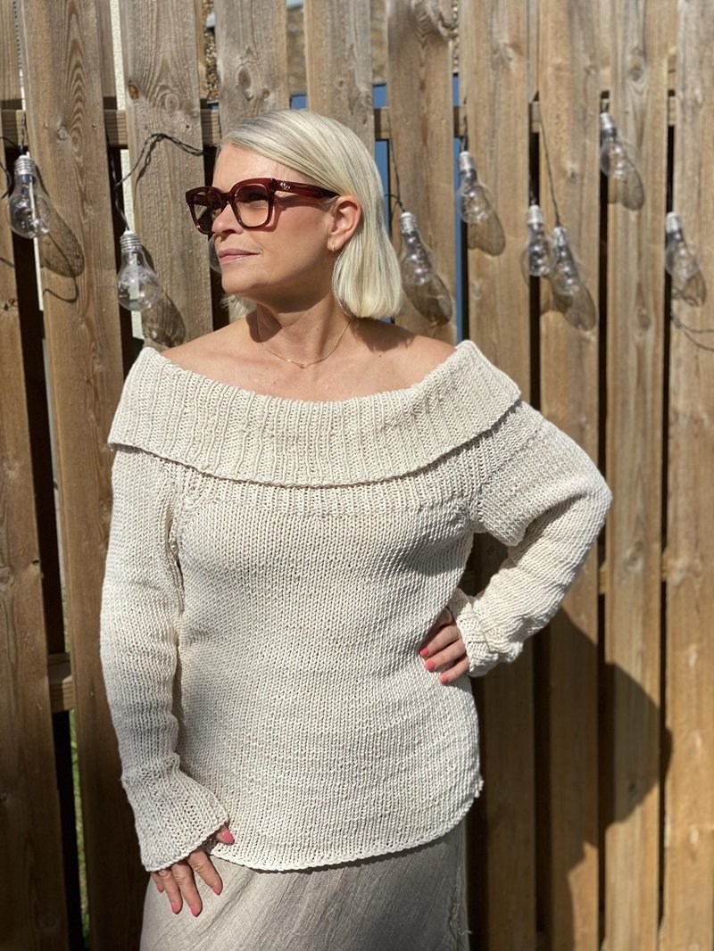 Woman wearing the chunky Bardot off-shoulder jumper #125 in cream, front view