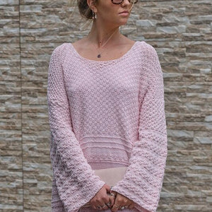 Woman wearing the Jumper Dress #136 in blossom pink with sunglasses