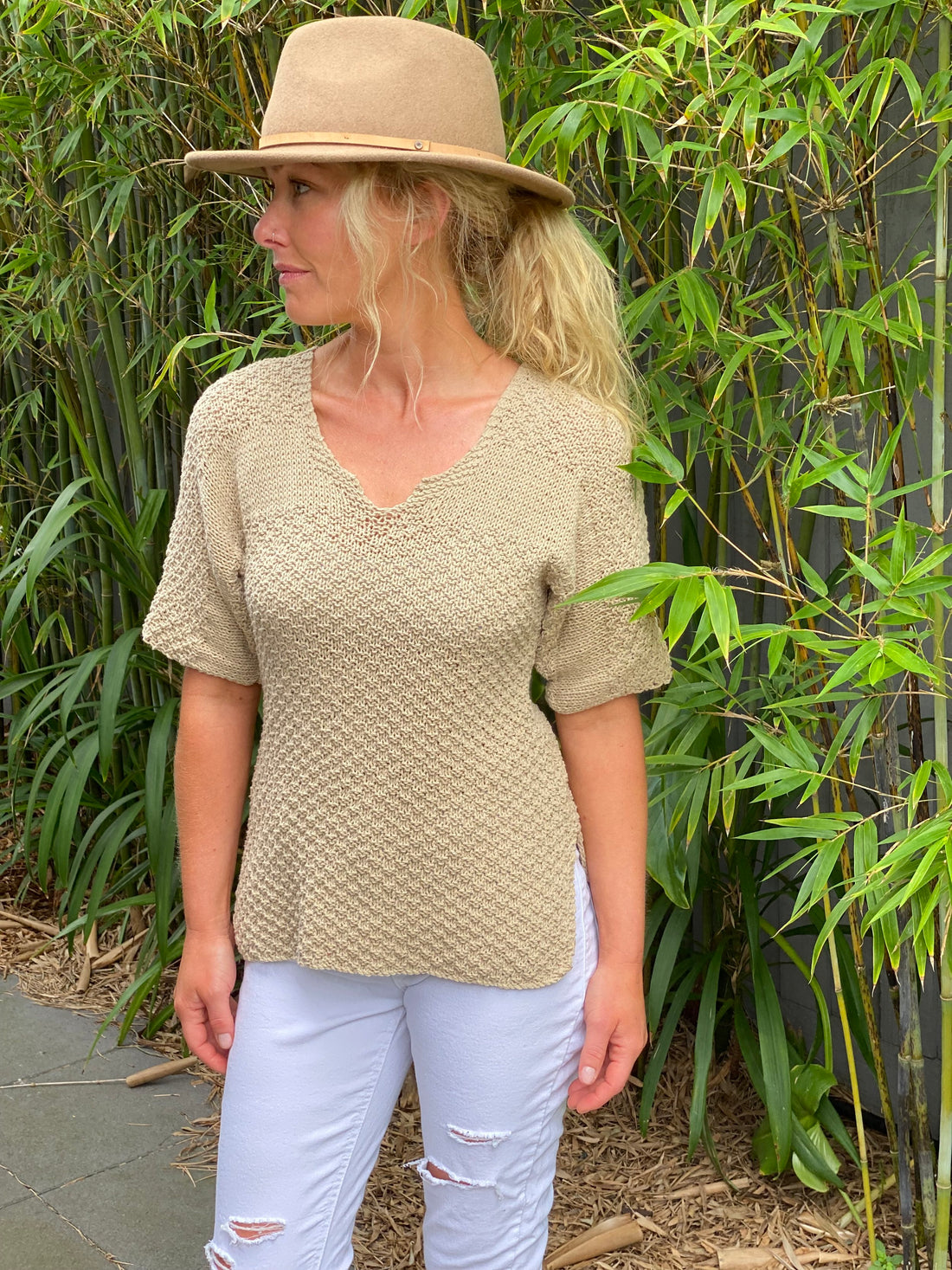 Woman in a straw hat wearing the Loose & Cool sweater #138 in natural with the short sleeve option