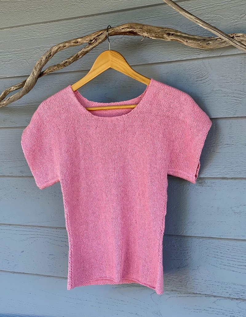 The Summer Top #174 in pink on a hanger, showing the crochet-finished neckline
