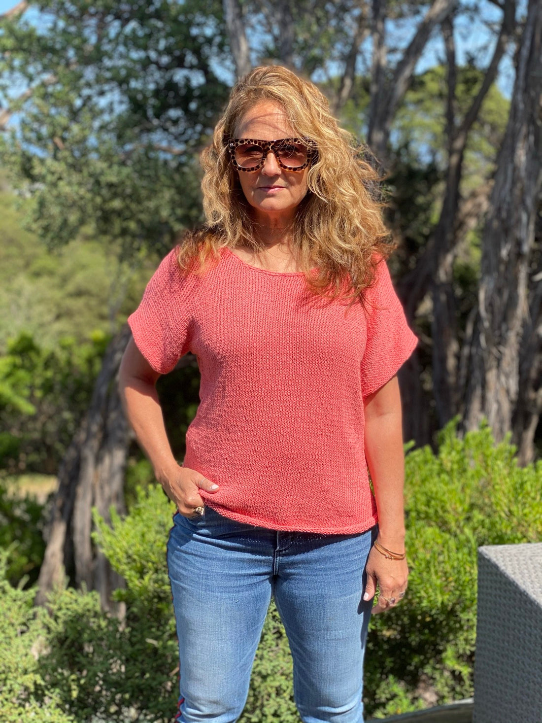 Woman wearing the Summer Top #174 in coral pink with jeans
