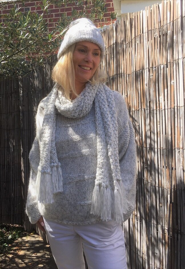 Runa Icicle Sweater #145 in ice with the matching blackberry stitch scarf and a knitted hat