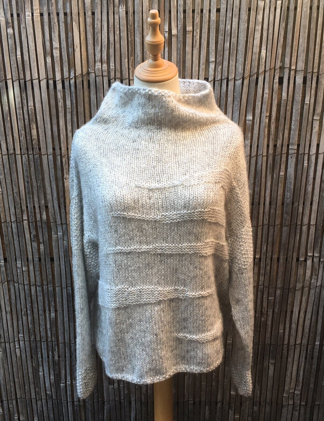 Runa Icicle Sweater #145 in pale grey on a dress form, showing the icicle texture and tall collar